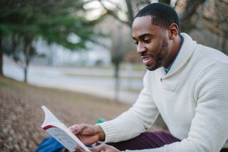 A man reading a book to be a lifelong learning